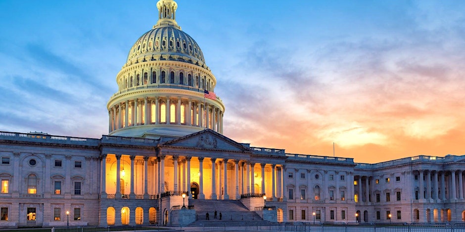 U.S. Capitol building at sunset with lights on inside